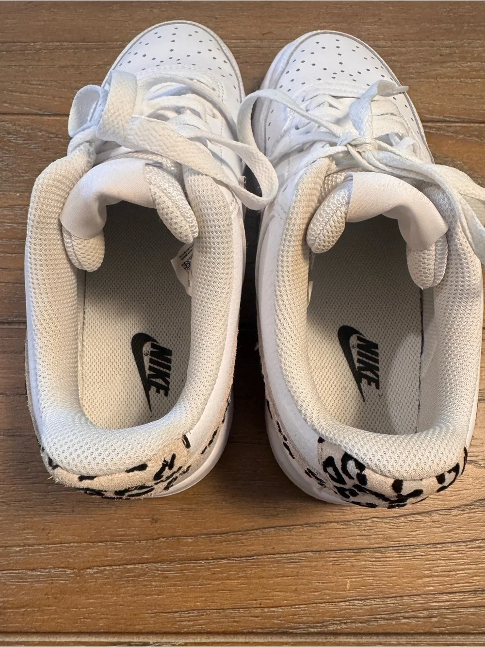 Nike White Low-Top Sneakers with Black Swoosh and Leopard Detail